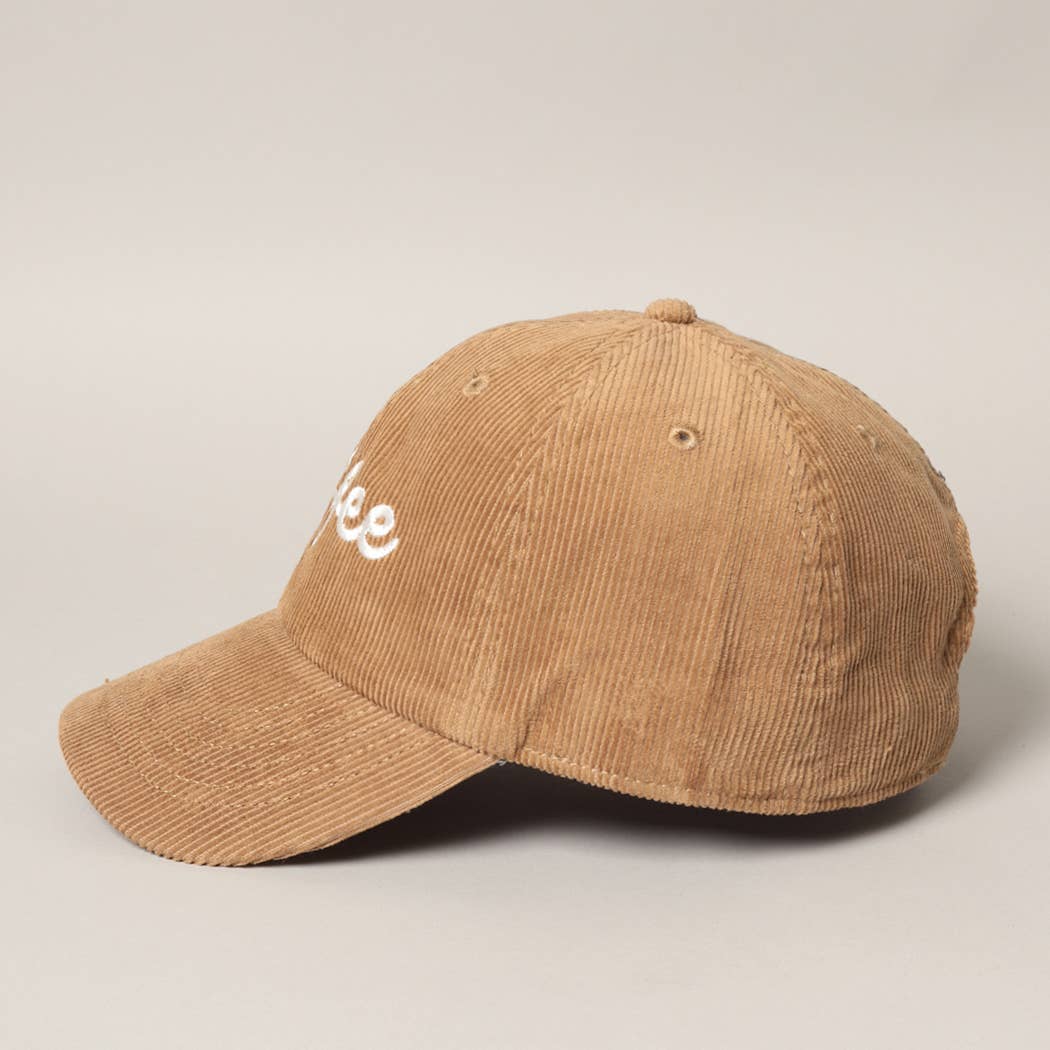 Tan corduroy cap from the side showing the pre-curved brim and eyelets