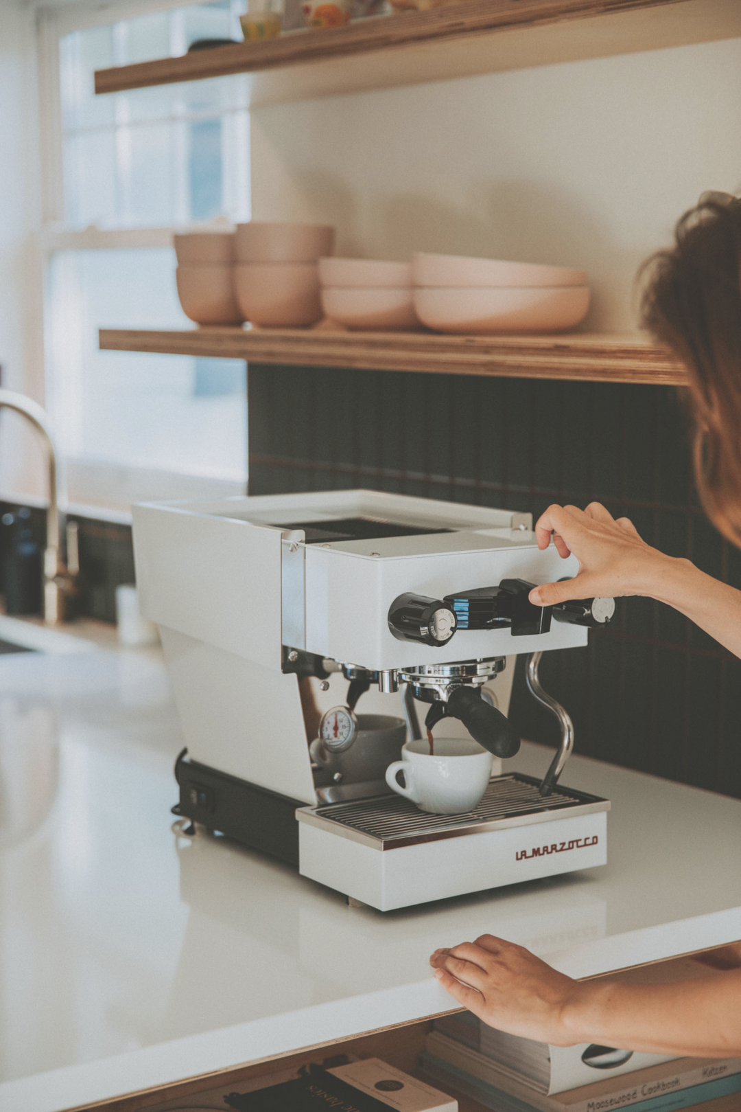 La Marzocco Linea Micra in Weiss – Lifestyle in heller Küche mit Person – Coffee Coaching Club